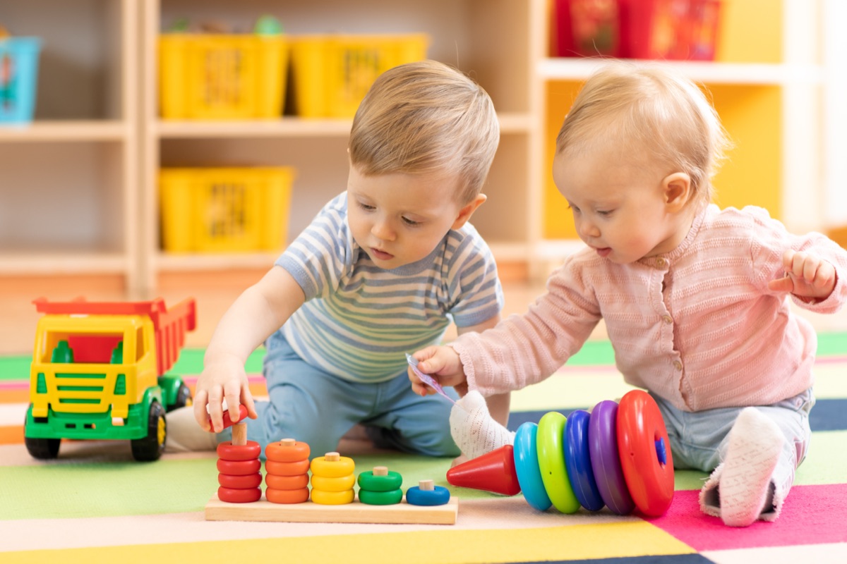 Dwoje maluchów bawi się układankami i drewnianą ciężarówką w polskim przedszkolu Klub Młodego Odkrywcy w Blanchardstown, Dublin 15